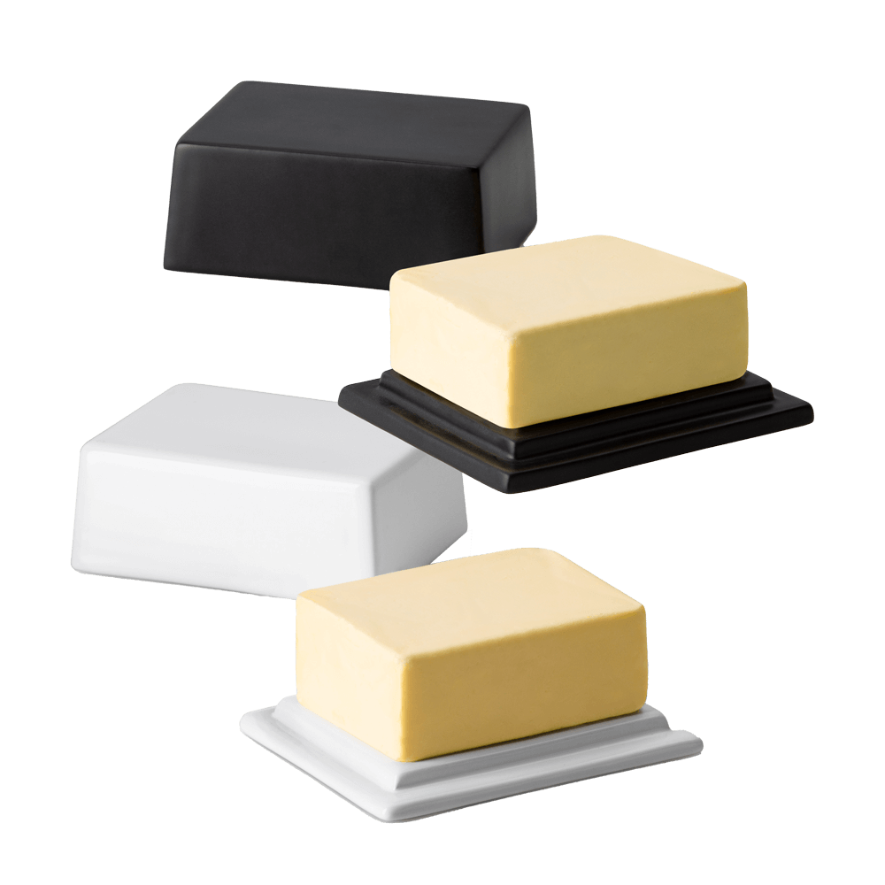 Butterdose in den Farben schwarz und weiß übereinander mit jeweils einer Butter ohne Hintergrund. Der Deckel liegt jeweils daneben.