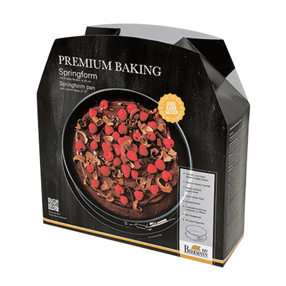 Premium Baking Springform Schwarze Verpackung mit der Aufschrift Premium Baking und darauf ist eine Kuchenform mit Schokoladenkuchen abgebildet und die Verpackung ist ohne Hintergrund abgebildet