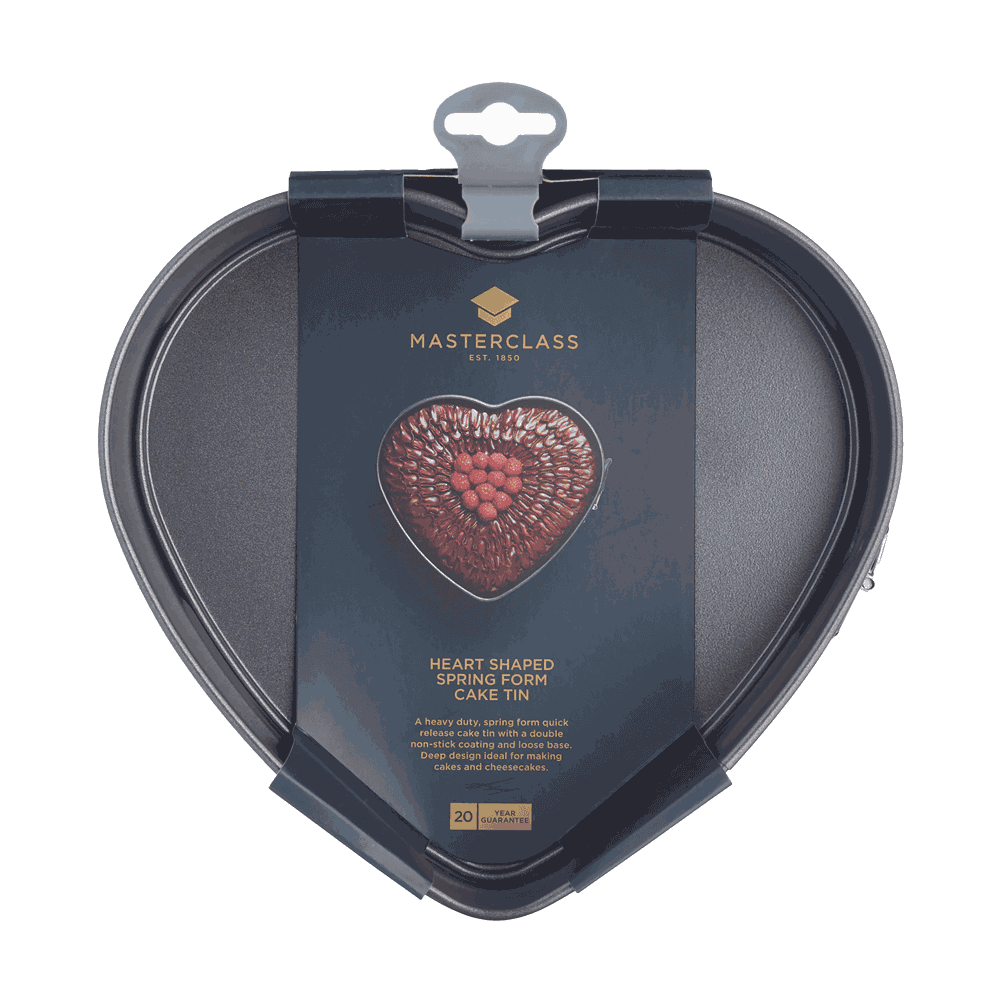 Herzförmige Kuchenform Herzförmige Springform-Kuchenform mit Antihaftbeschichtung in schwarzer Farbe, abgebildet in der Originalverpackung mit einer Beispielabbildung eines dekorierten Herzkuchens auf der Vorderseite.