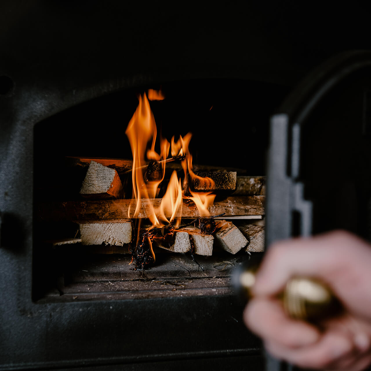 Holzbackofen_entzündet Abbildung zeigt einen Häussler Holzbackofen, in dessen Innenraum das Anzündholz brennt.