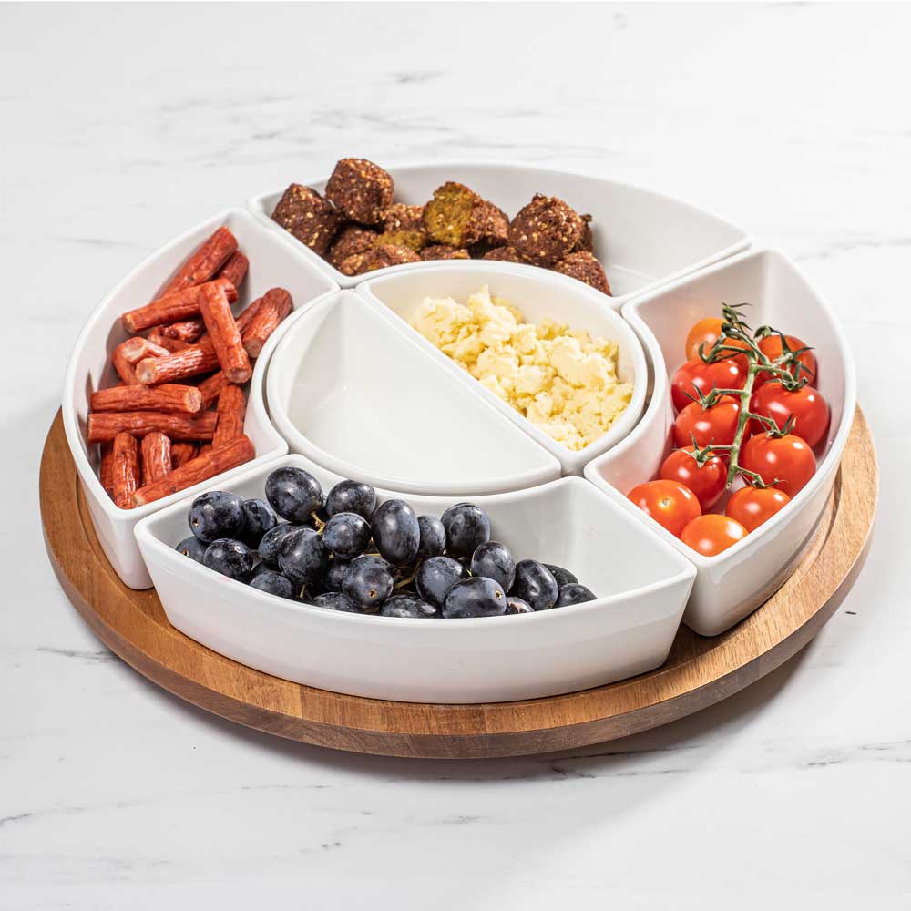 Drehteller gefüllt mit verschiedenen Snacks auf einer Küchenarbeitsplatte.