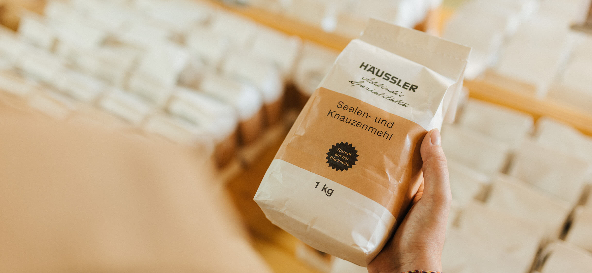 Mehle und Backmischungen Kunde hält eine Mehltüte in der Hand und liest das Etikett