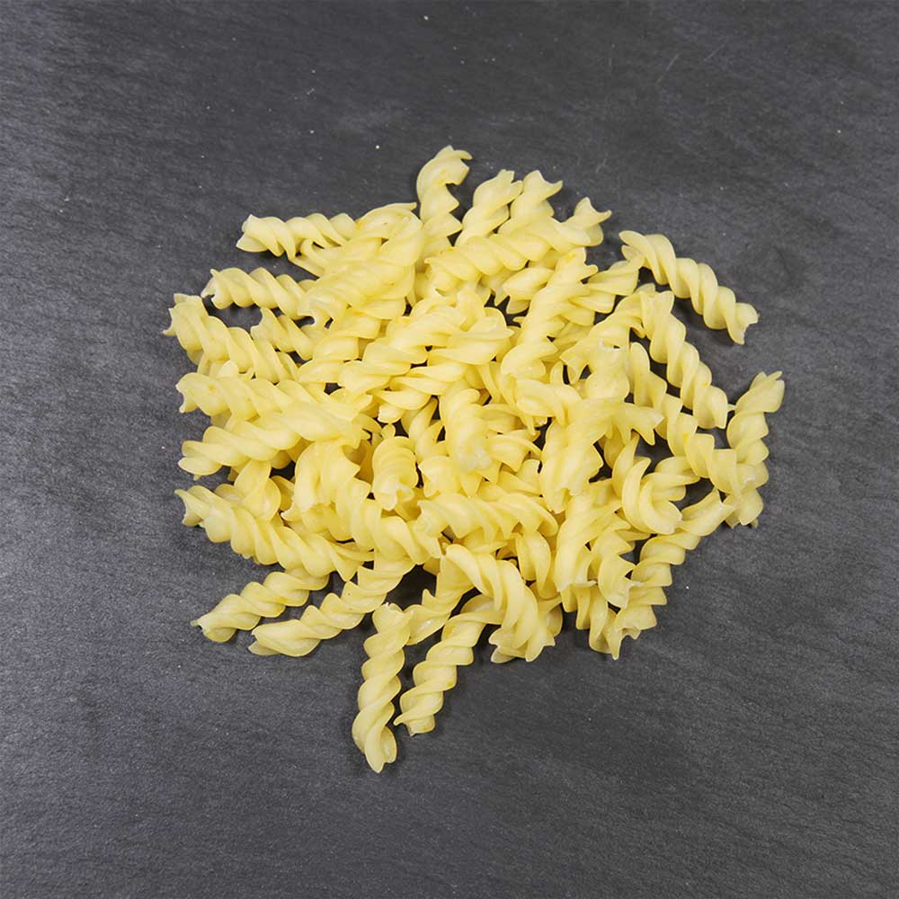 Hartweizengrieß zu Nudeln verarbeitet Nudeln aus Hartweizengrieß auf dunklem Hintergrund