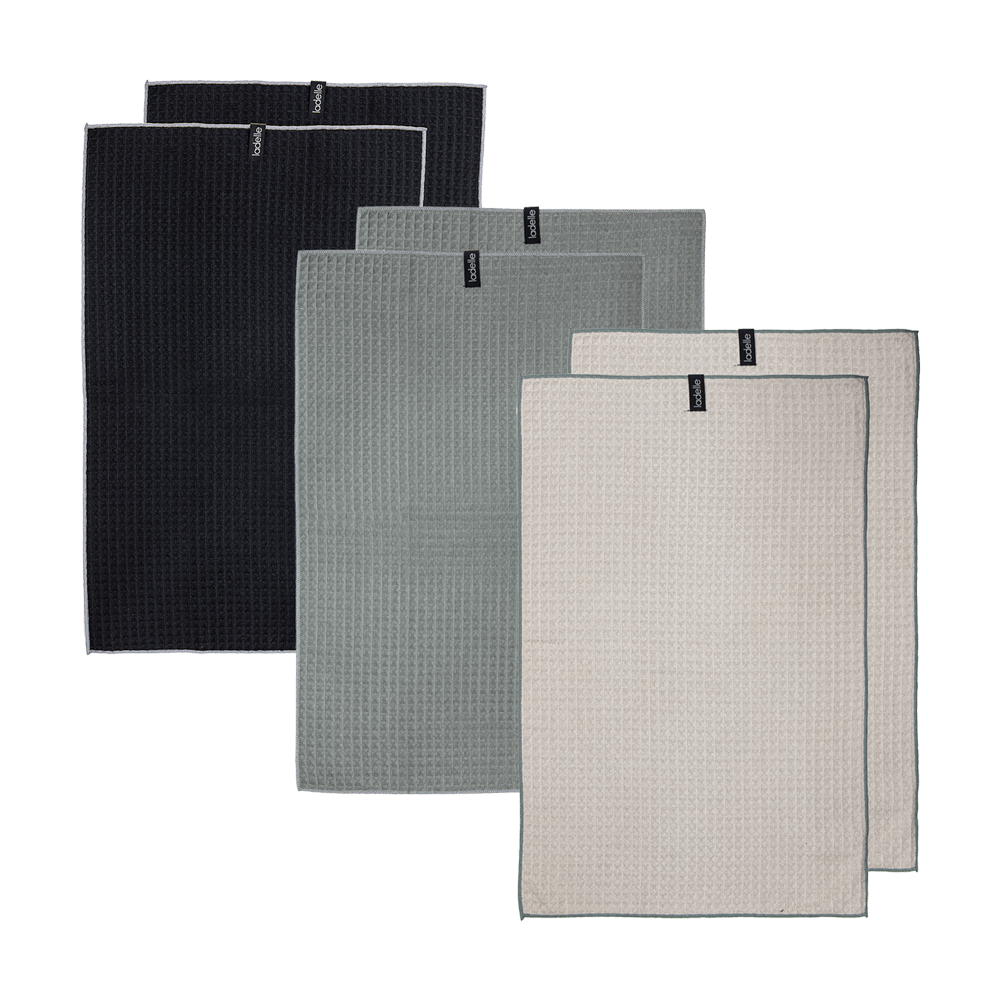 Geschirrtücher in den Farben schwarz, salbeigrün und taupe nebeneinander ohne Hintergrund.