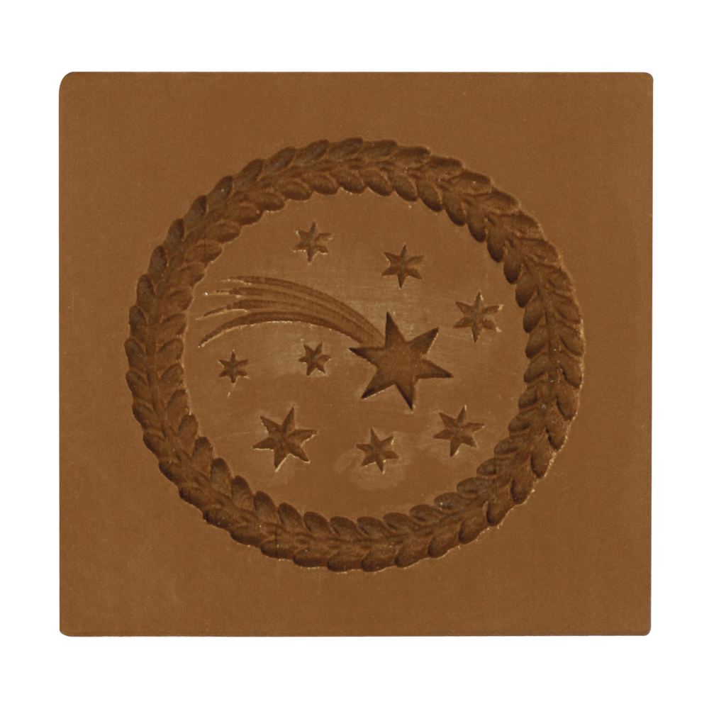 Springerle-Model Stern von Bethlehem Braunes Springerle-Model aus Bio-Kunststoff mit einer Sternschnuppe, Sternen und einem Kranz als Motiv. Ohne Hintergrund abgebildet.